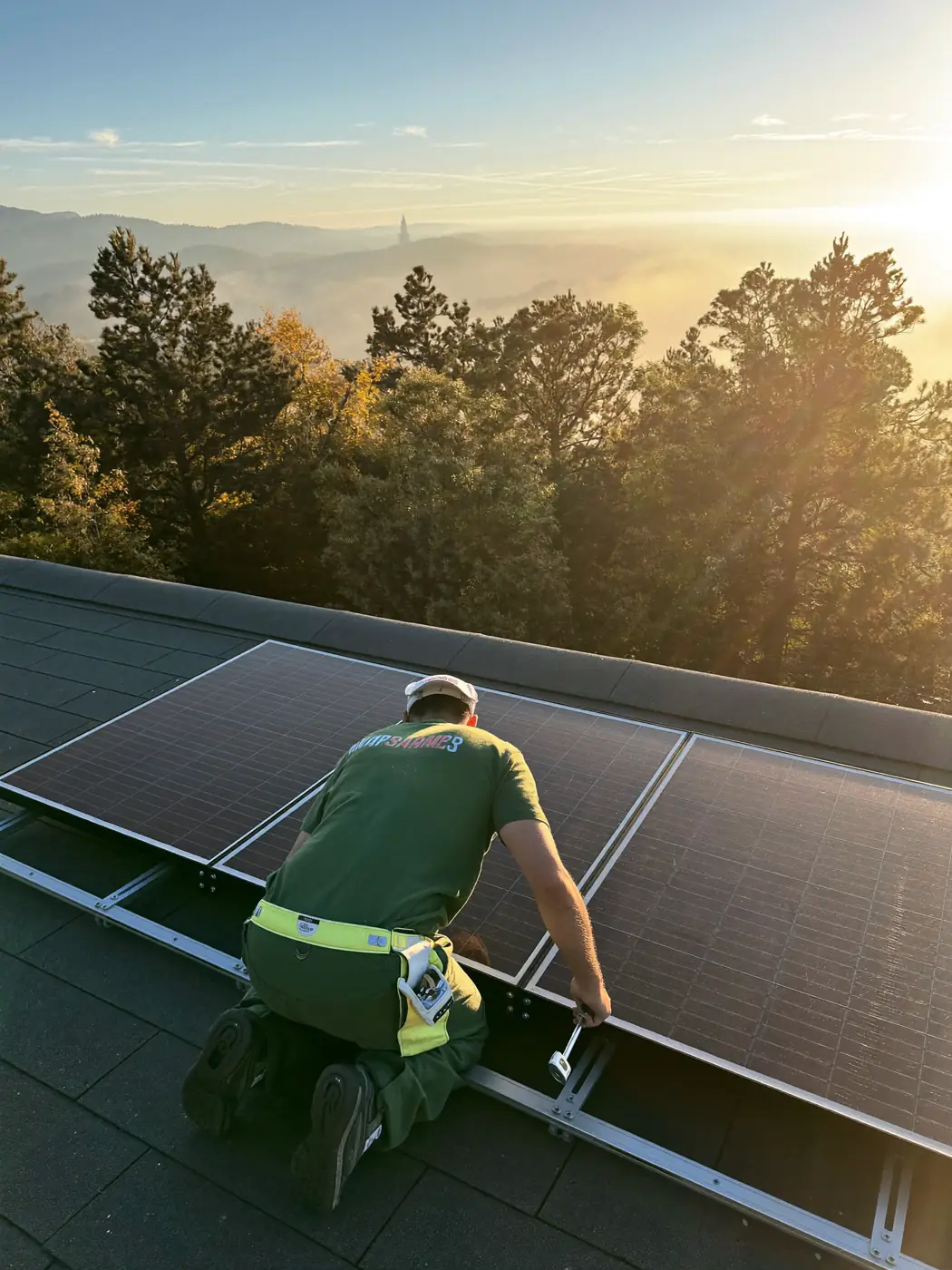 A technician bolting a panel into its mounting rail