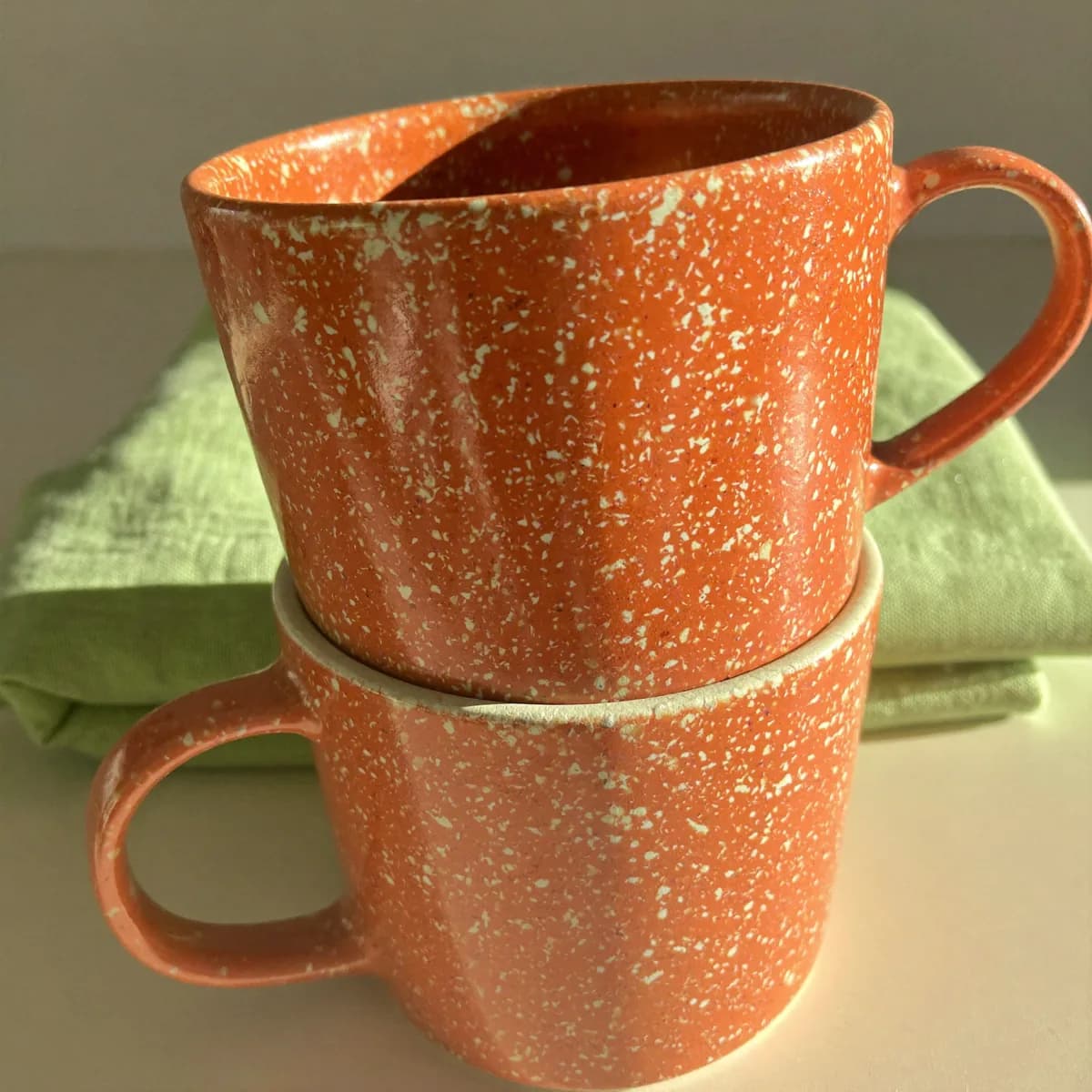 A stack of speckled mugs