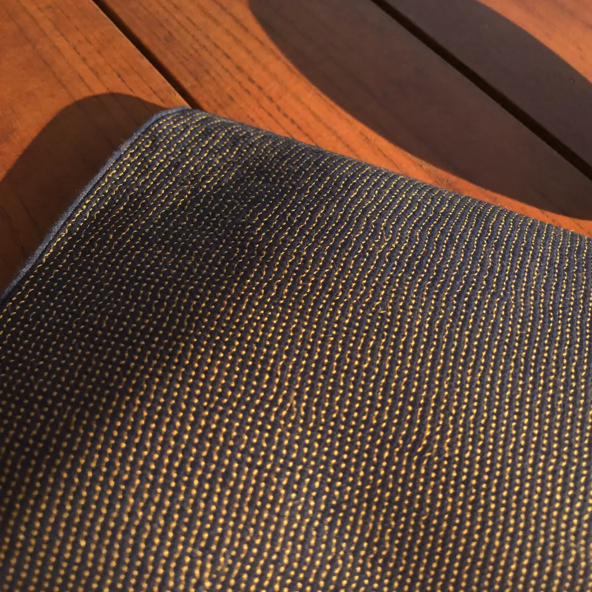 Handwoven indigo silk shot through with fine gold weft