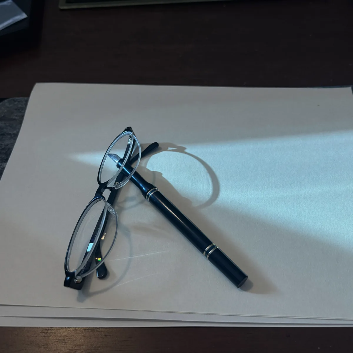 A bound file and pen set down on a desk