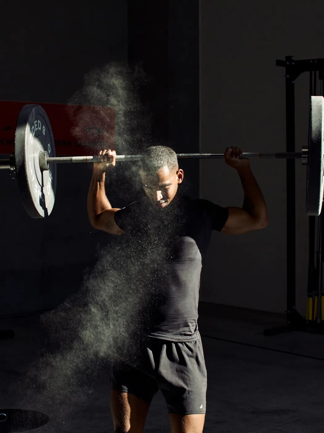 A coach watching an athlete complete a lift